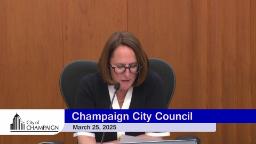 Mayor Feinen at Council Dias with Graphic reading Champaign City Council
