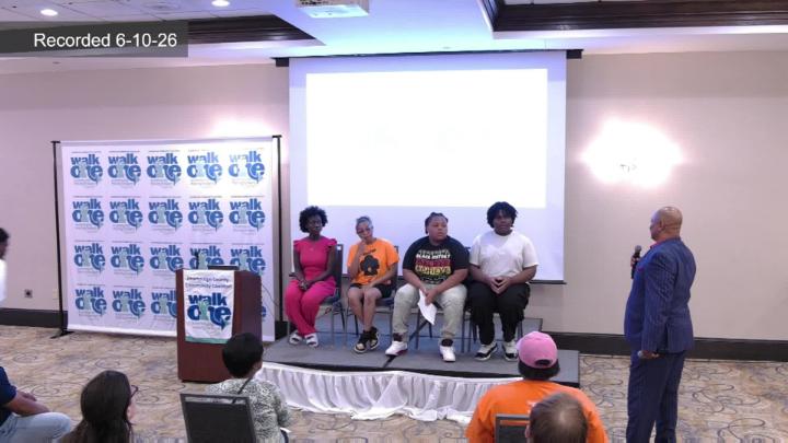 Group of student panelist at the front of the conference room. 