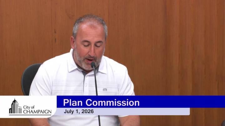 Plan Commission Chairperson at Dais in front of microphone.